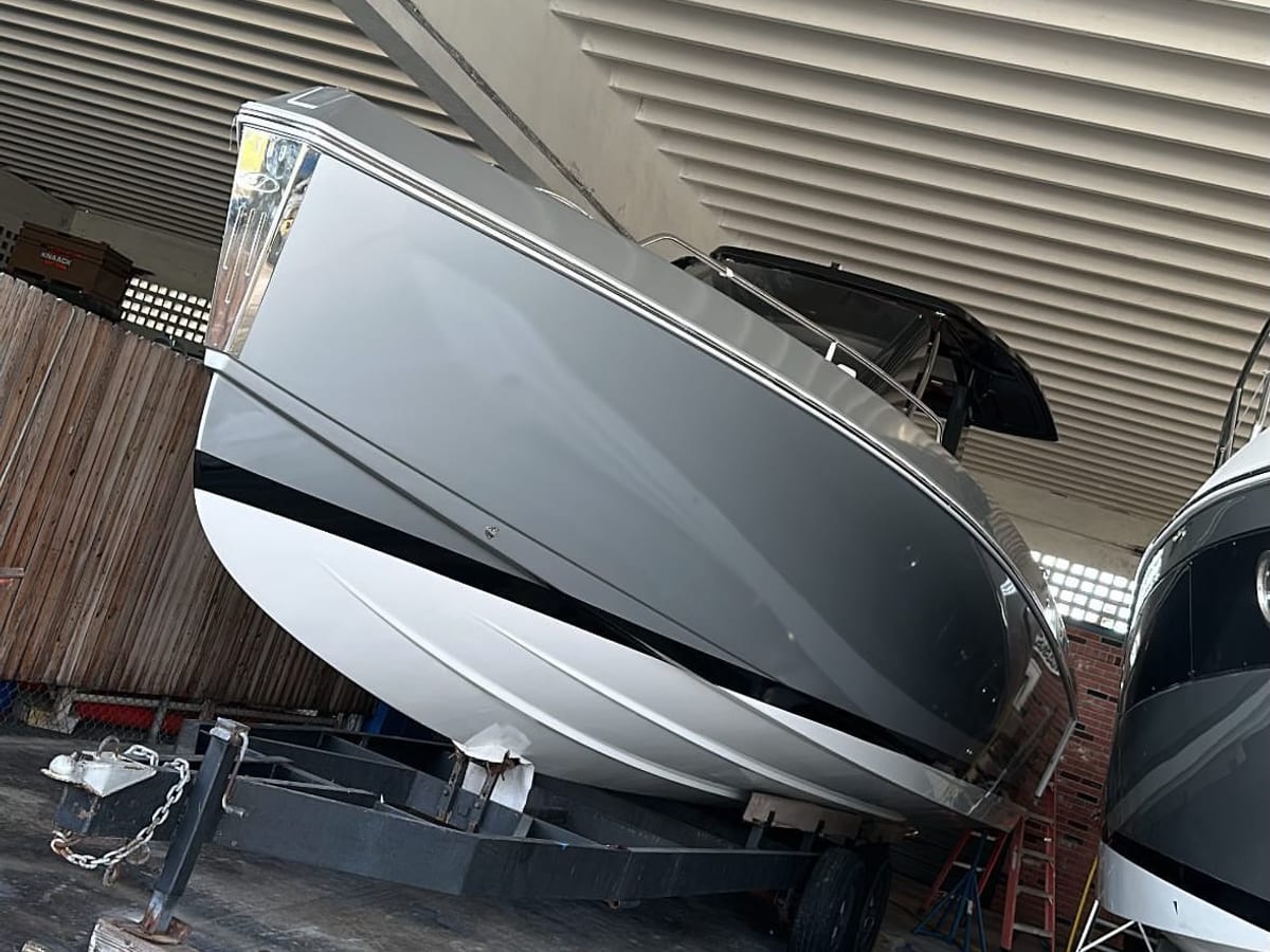 Center console boat in gray and white under cover
