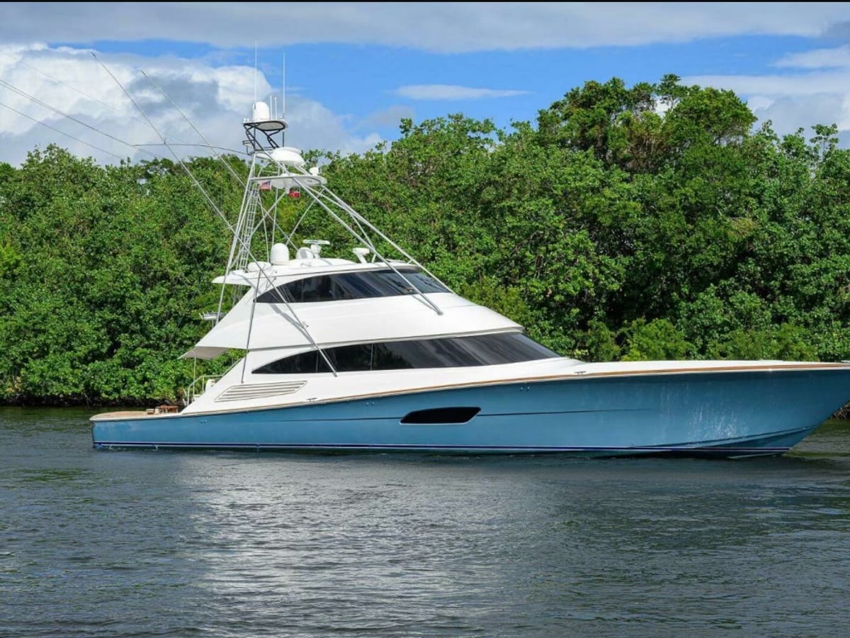 Sportfish yacht with a blue hull on calm water